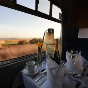 A set table with the rolling countryside in the background